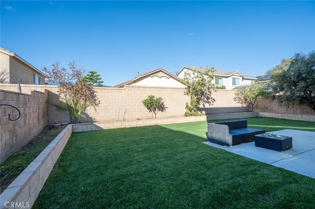 a backyard of a house with table and chairs