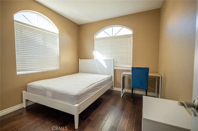 a bedroom with a bed a table and chair