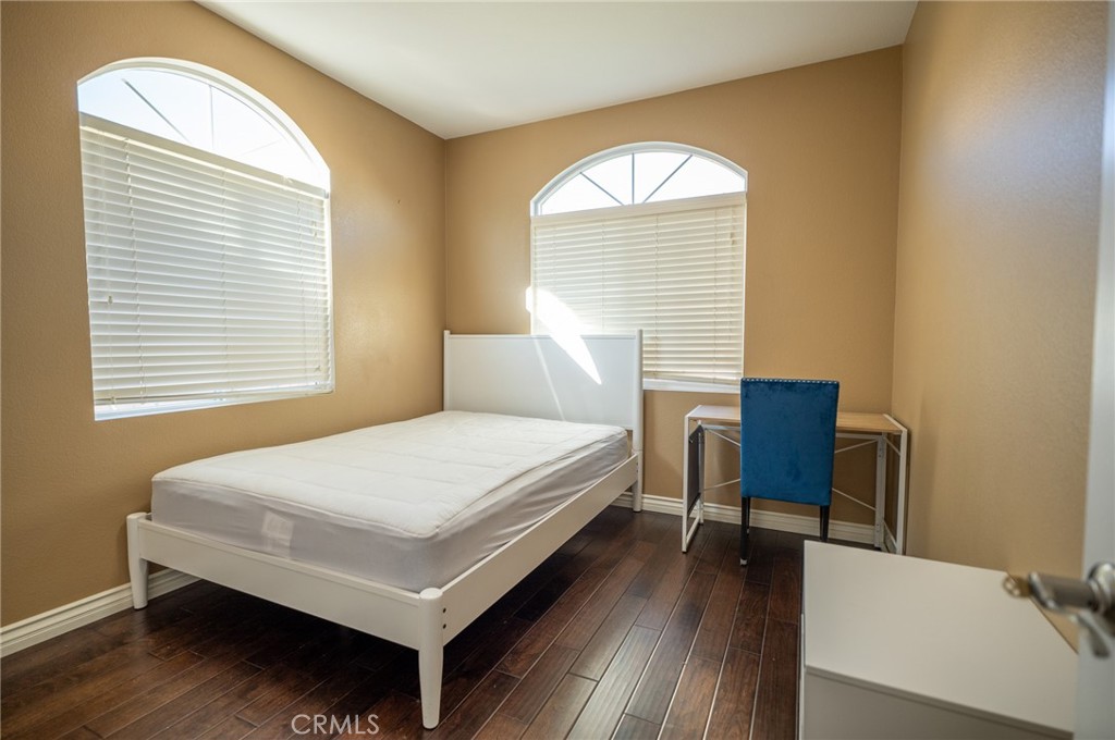 13208 Firestone Drive Rancho Cucamonga, CA 91739 - Photo 9 of 21 a bedroom with a bed a table and chair
