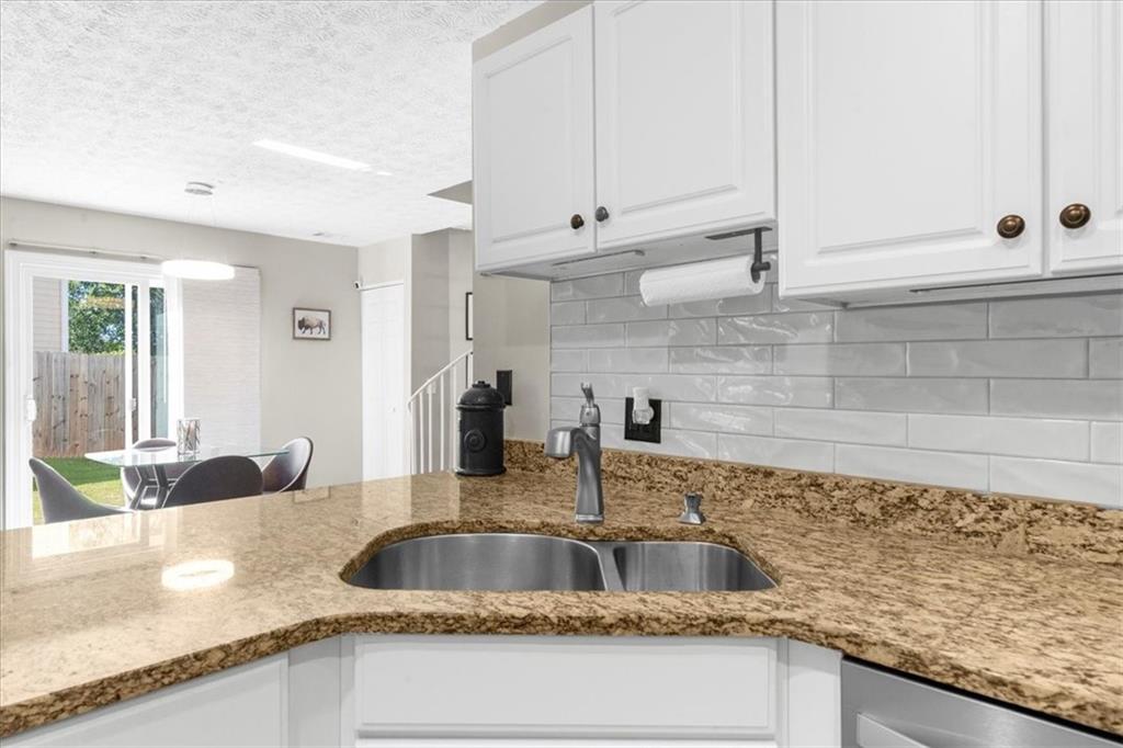 820 Camelon Court Alpharetta, GA 30004 - Photo 11 of 33 a kitchen with granite countertop a sink and a wooden floor