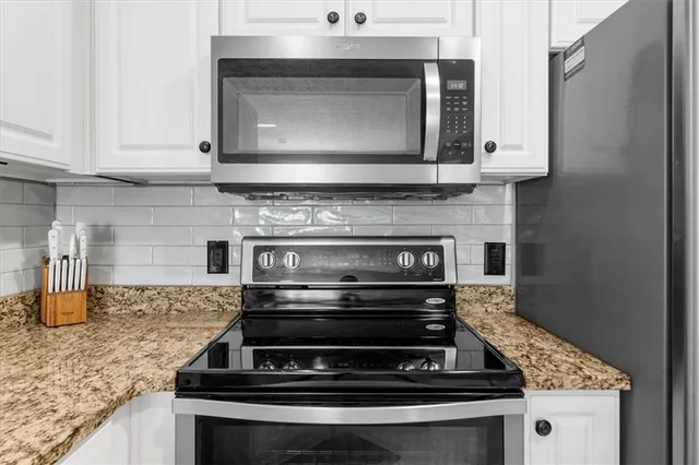 a stove top oven sitting inside of a kitchen