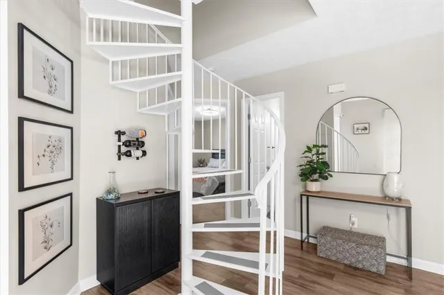 a view of staircase with wooden floor and cabinet