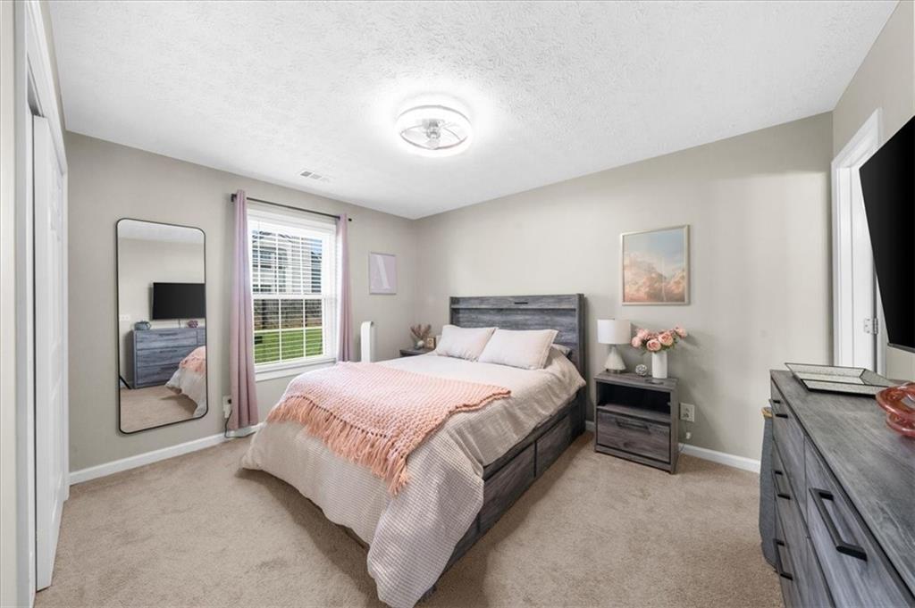 820 Camelon Court Alpharetta, GA 30004 - Photo 21 of 33 a bedroom with a bed and a large window