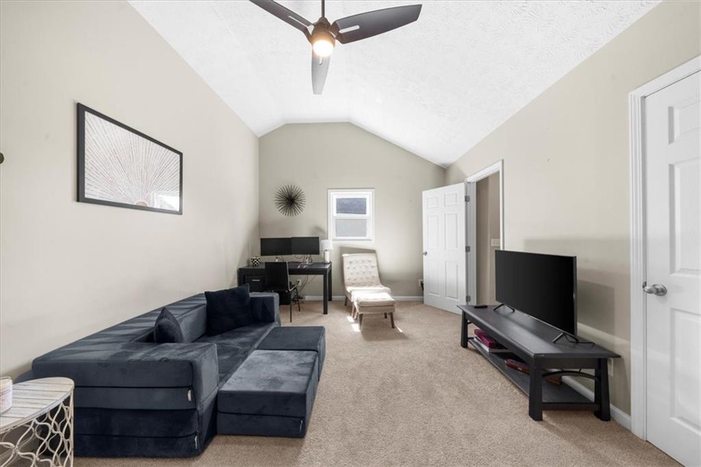 820 Camelon Court Alpharetta, GA 30004 - Photo 25 of 33 a living room with furniture and a flat screen tv