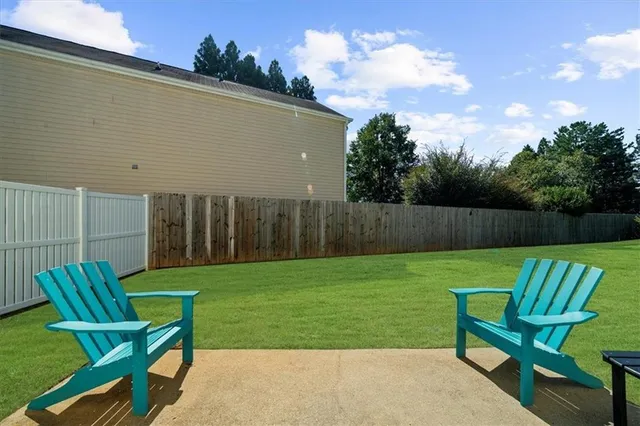 a view of a chair and table in the backyard