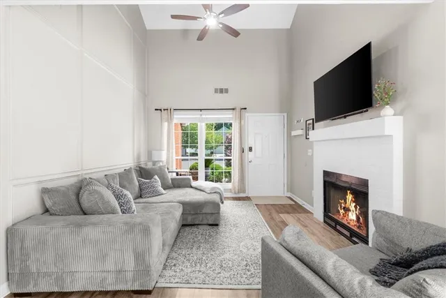 a living room with furniture a fireplace and a flat screen tv
