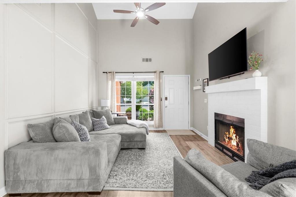 820 Camelon Court Alpharetta, GA 30004 - Photo 6 of 33 a living room with furniture a fireplace and a flat screen tv