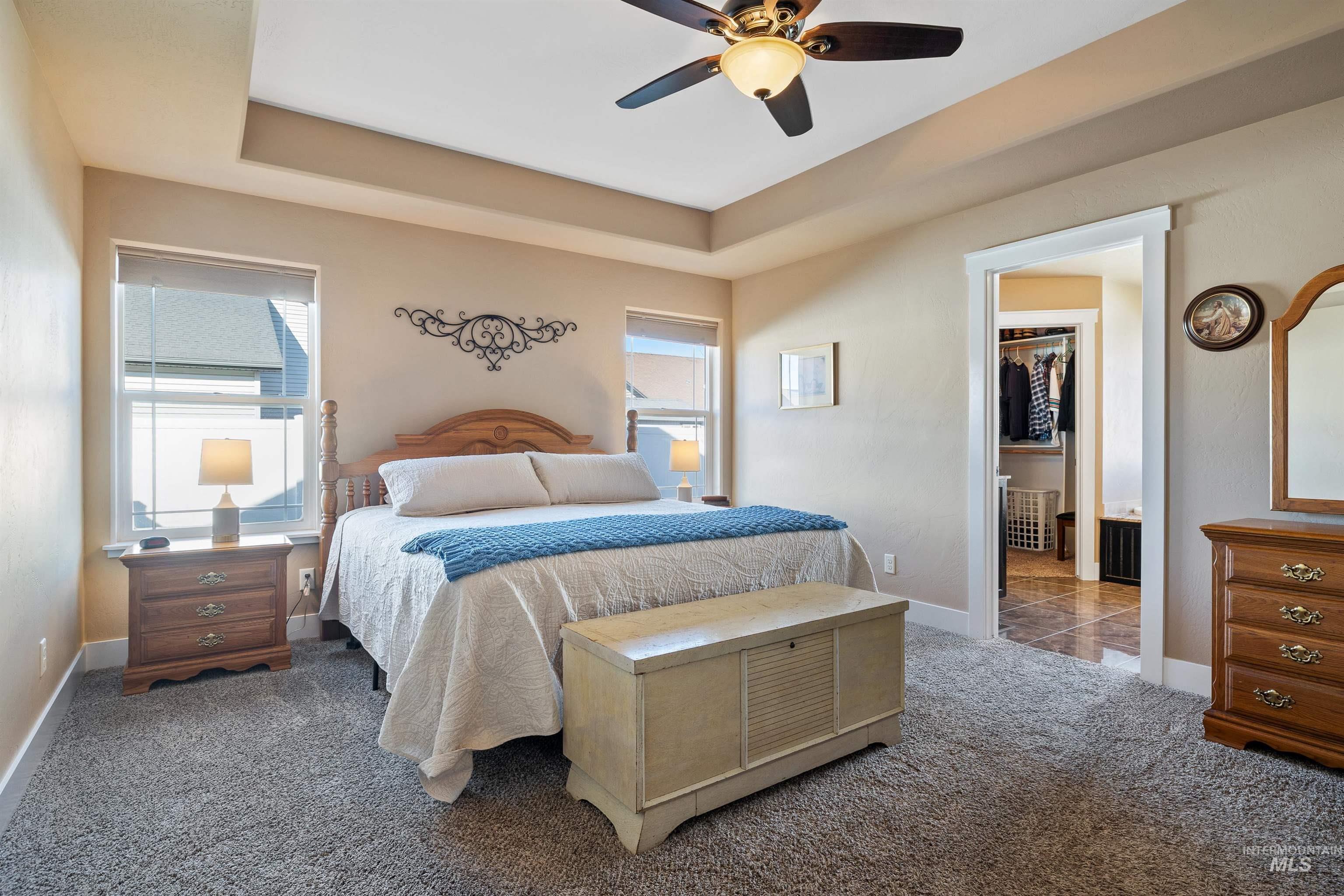 330 Arrowhead Path Twin Falls, ID 83301 - Photo 10 of 37 Bedroom with a ceiling fan, a raised ceiling, and carpet