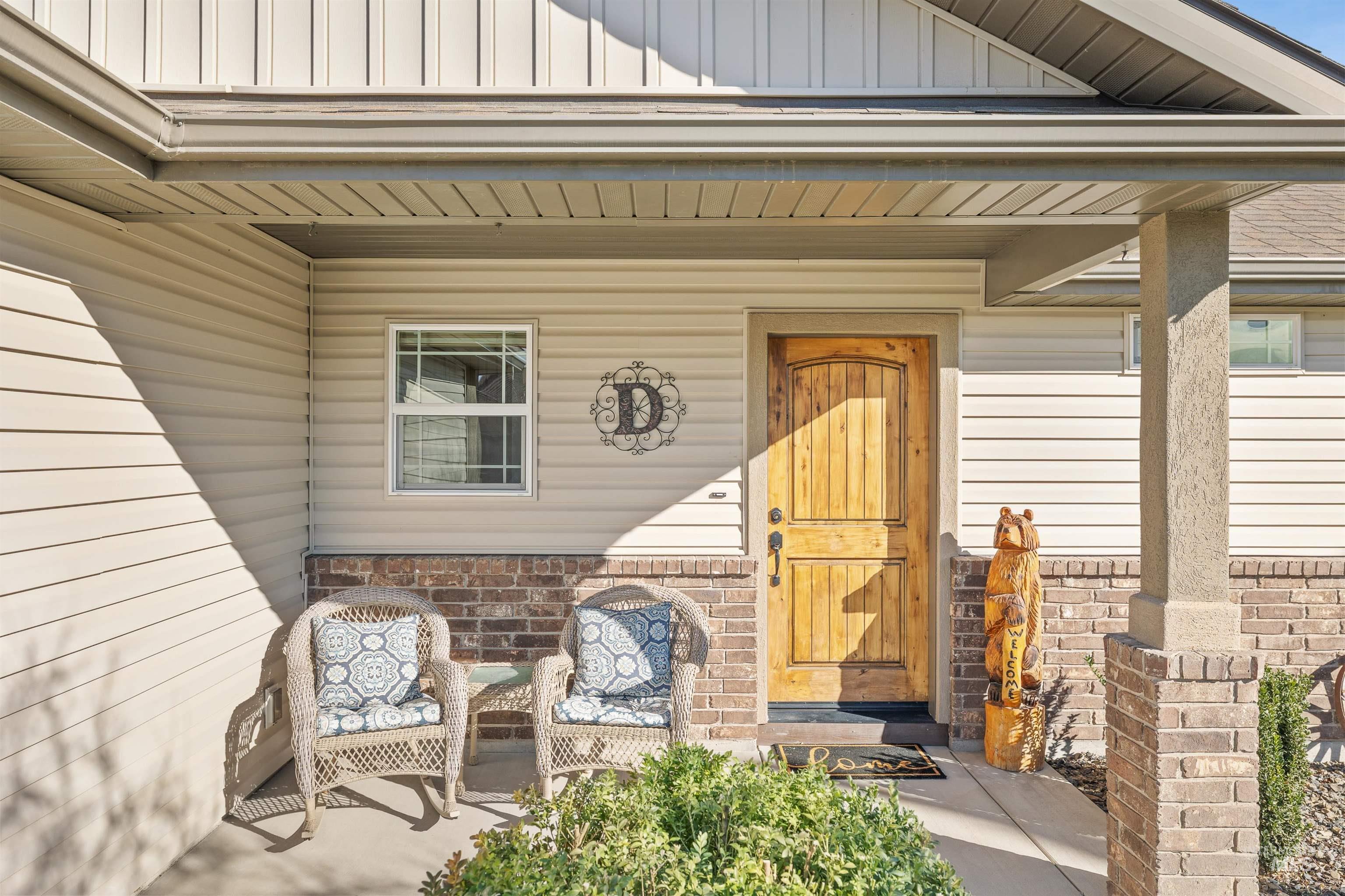 330 Arrowhead Path Twin Falls, ID 83301 - Photo 2 of 37 Entrance to property with a porch, board and batten siding, and brick siding
