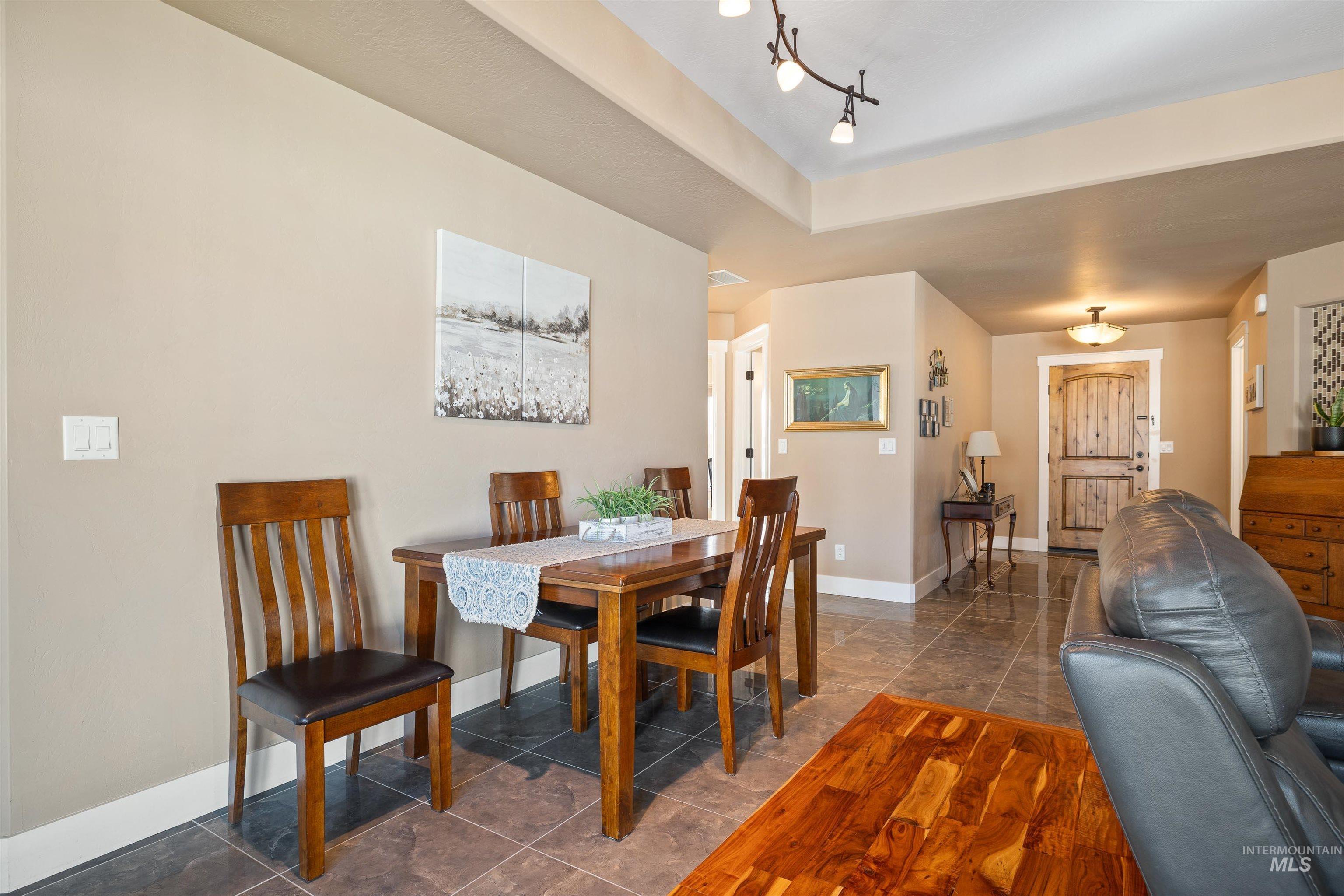330 Arrowhead Path Twin Falls, ID 83301 - Photo 6 of 37 Dining space with dark tile patterned flooring, a raised ceiling, and track lighting