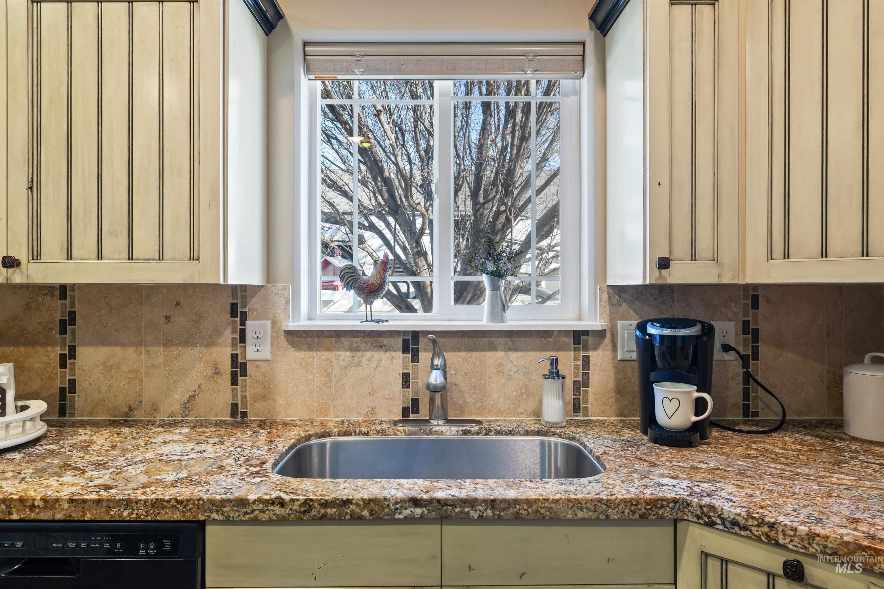 330 Arrowhead Path Twin Falls, ID 83301 - Photo 9 of 37 Kitchen with light stone countertops, dishwasher, green cabinetry, and tasteful backsplash