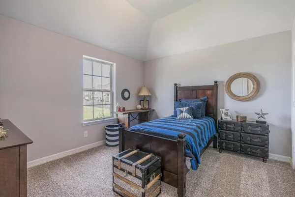 a bed room with a bed and a window