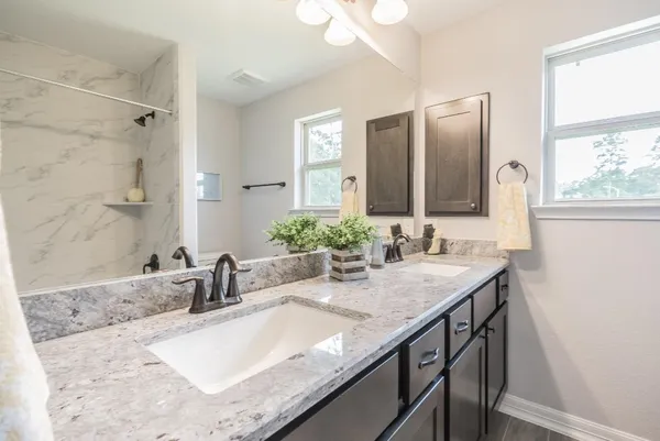 a bathroom with granite countertop a sink and a mirror