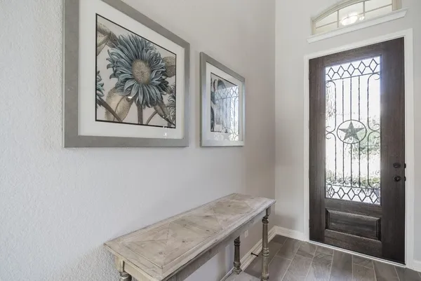 a view of hallway with window and wooden floor