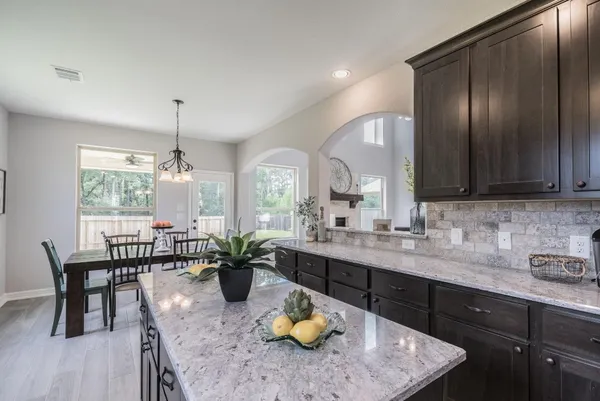 a kitchen with sink and chairs