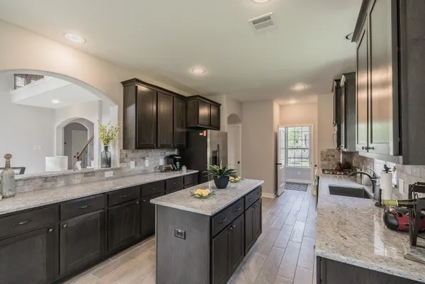 a bathroom with double vanity and a mirror