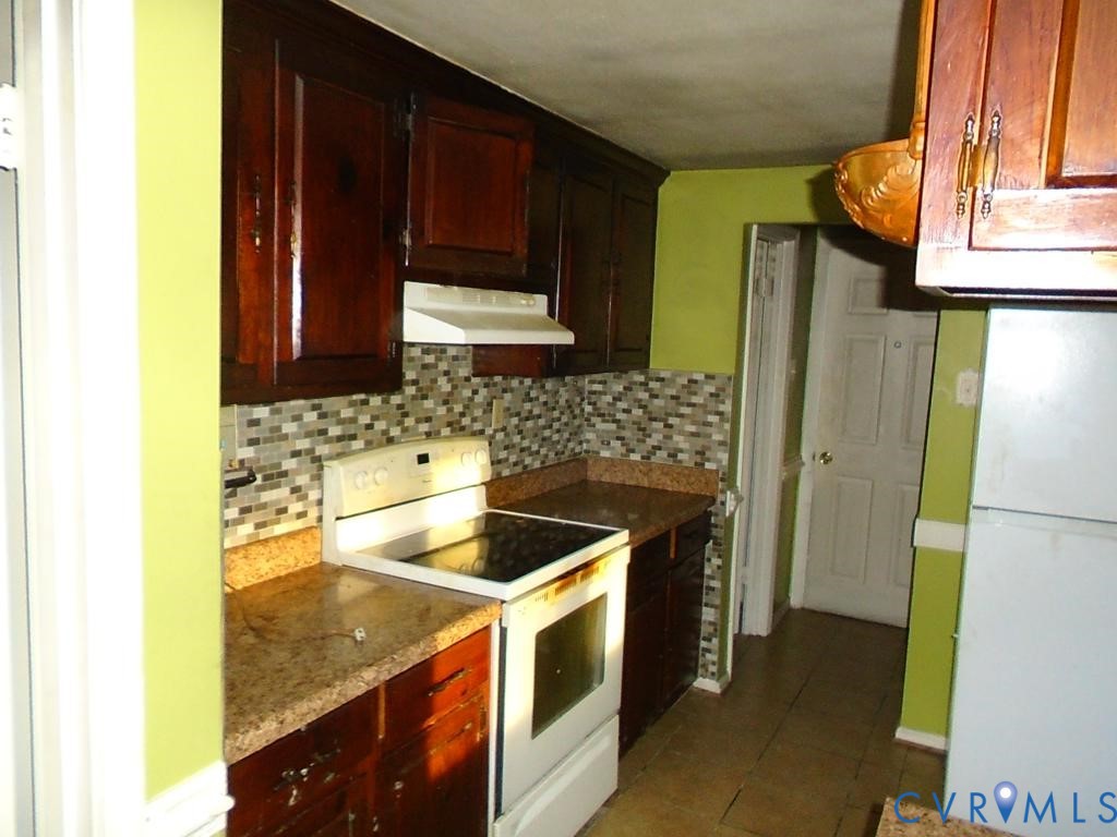 16203 West Patrick Henry Road Montpelier, VA 23192 - Photo 18 of 23 Kitchen featuring wood-finish cabinetry, speckled