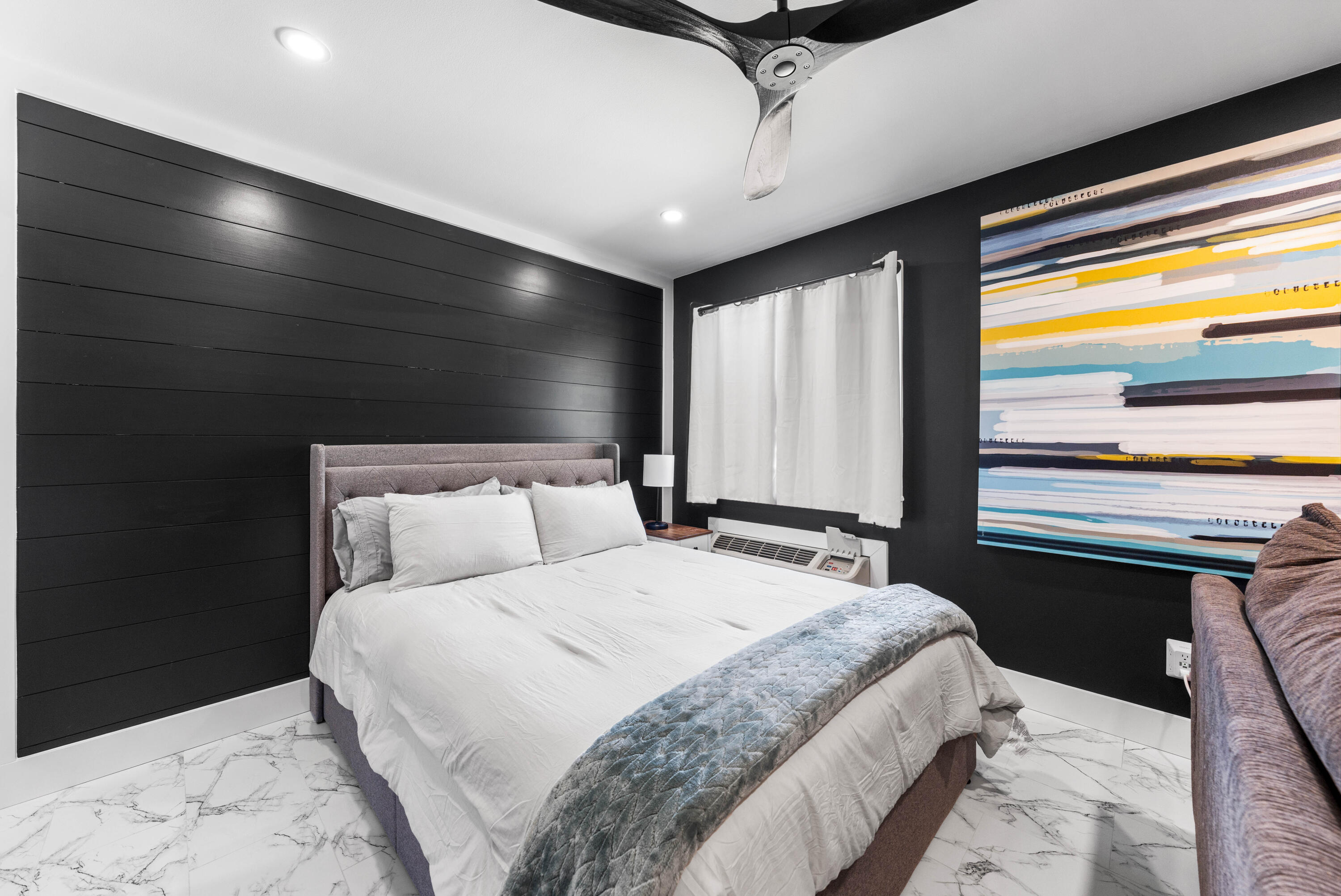 101 Cain Road, Unit O Panama City Beach, FL 32413 - Photo 14 of 29 a bedroom with a large bed and a large window