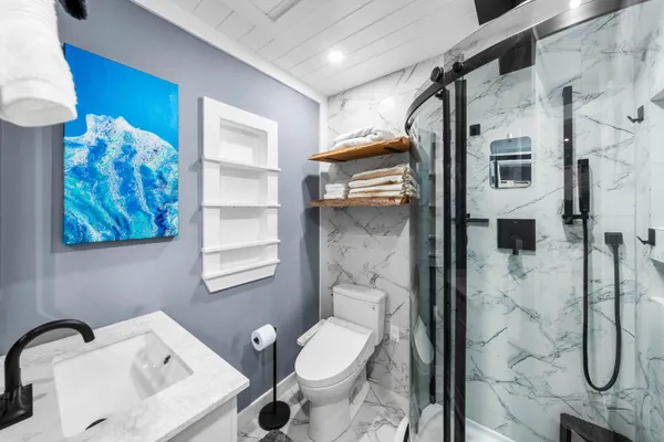 a bathroom with a toilet sink and shower