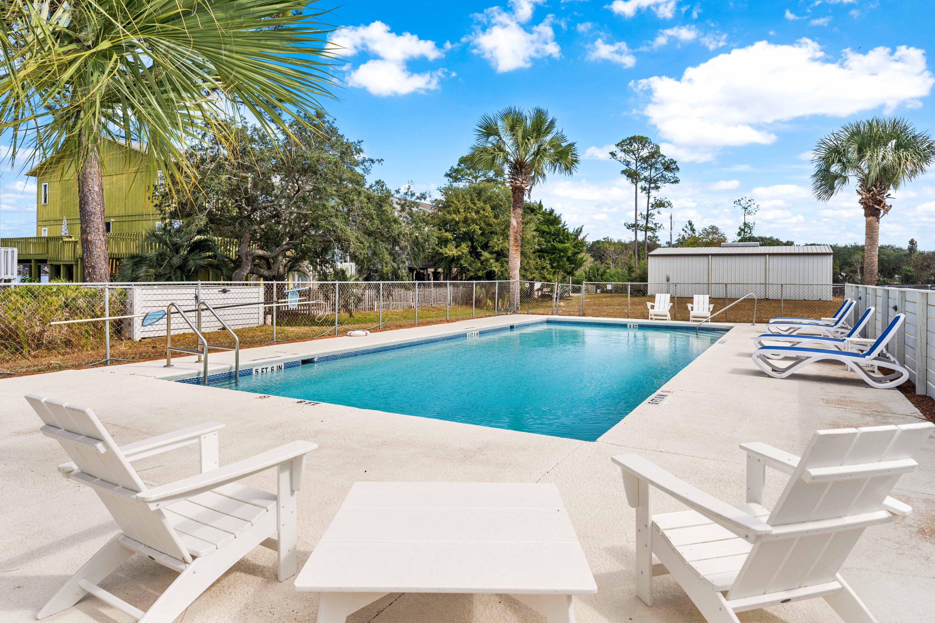101 Cain Road, Unit O Panama City Beach, FL 32413 - Photo 20 of 29 a view of a swimming pool with an outdoor seating
