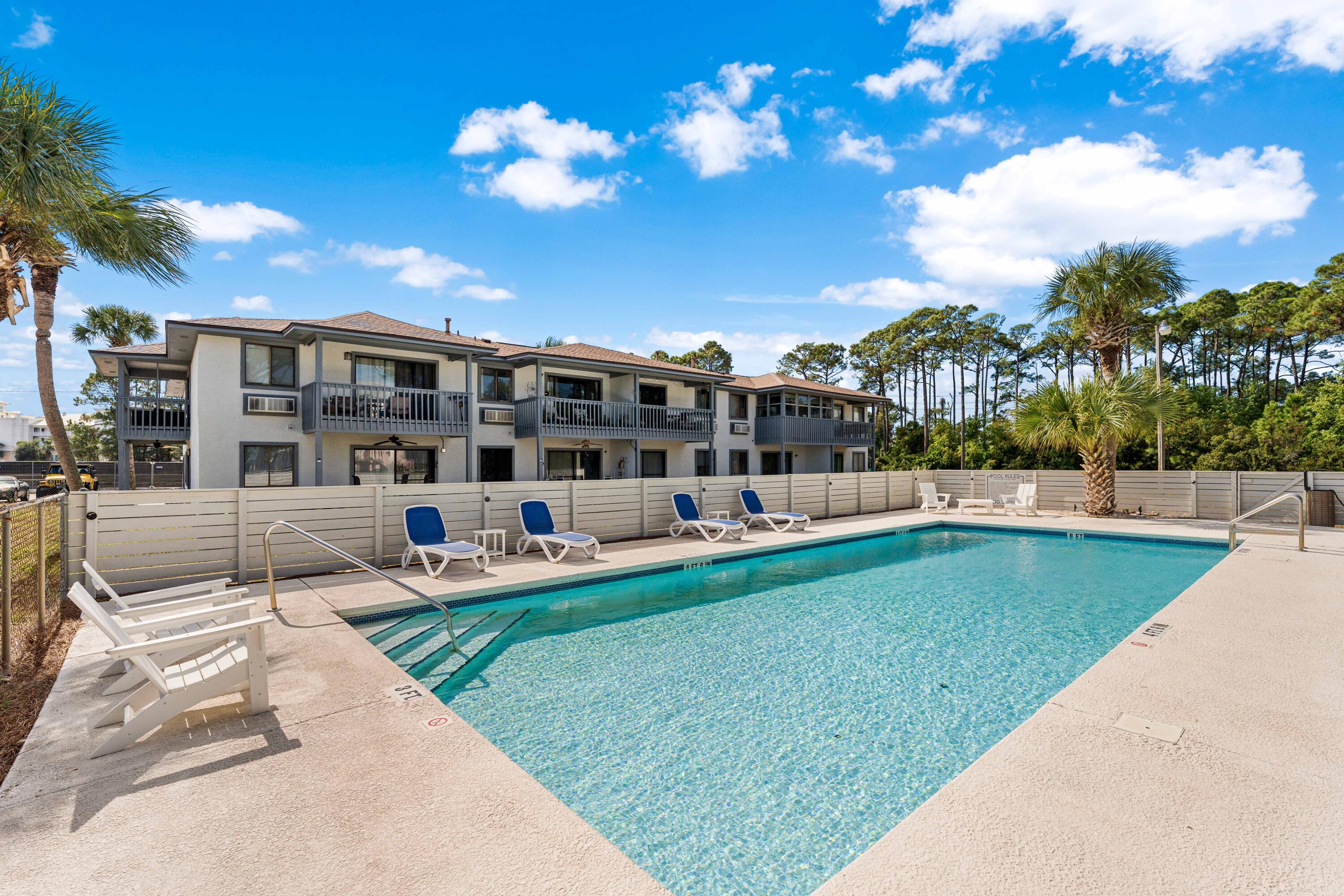 101 Cain Road, Unit O Panama City Beach, FL 32413 - Photo 21 of 29 a view of a swimming pool with a patio