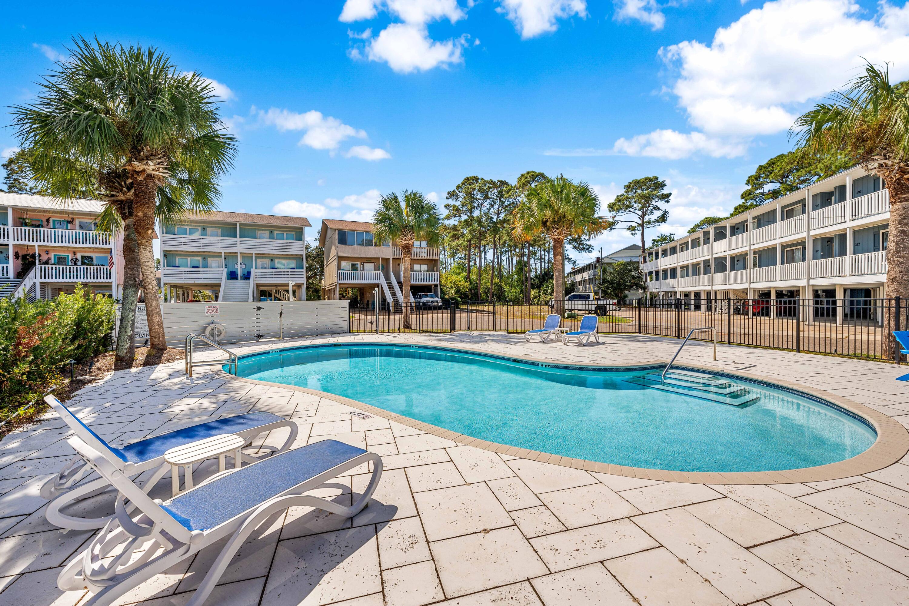 101 Cain Road, Unit O Panama City Beach, FL 32413 - Photo 23 of 29 a view of a swimming pool with a patio