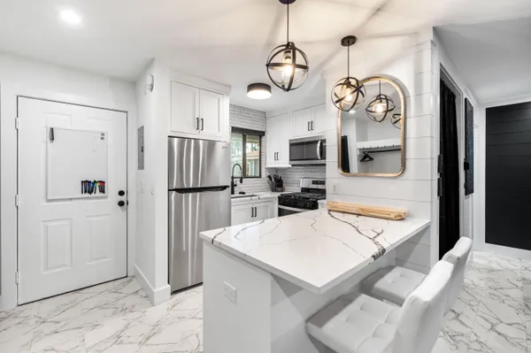 a view of a kitchen and a refrigerator