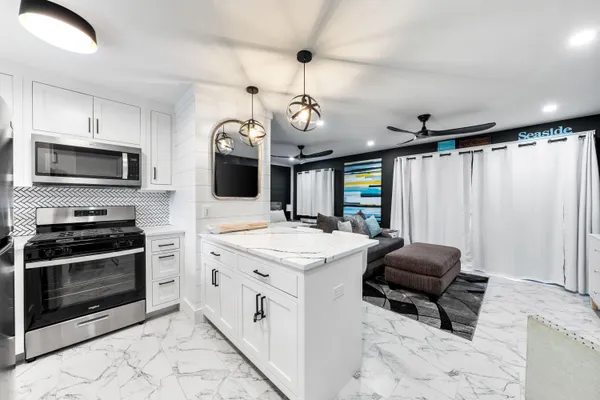 a kitchen with a stove a sink and a microwave