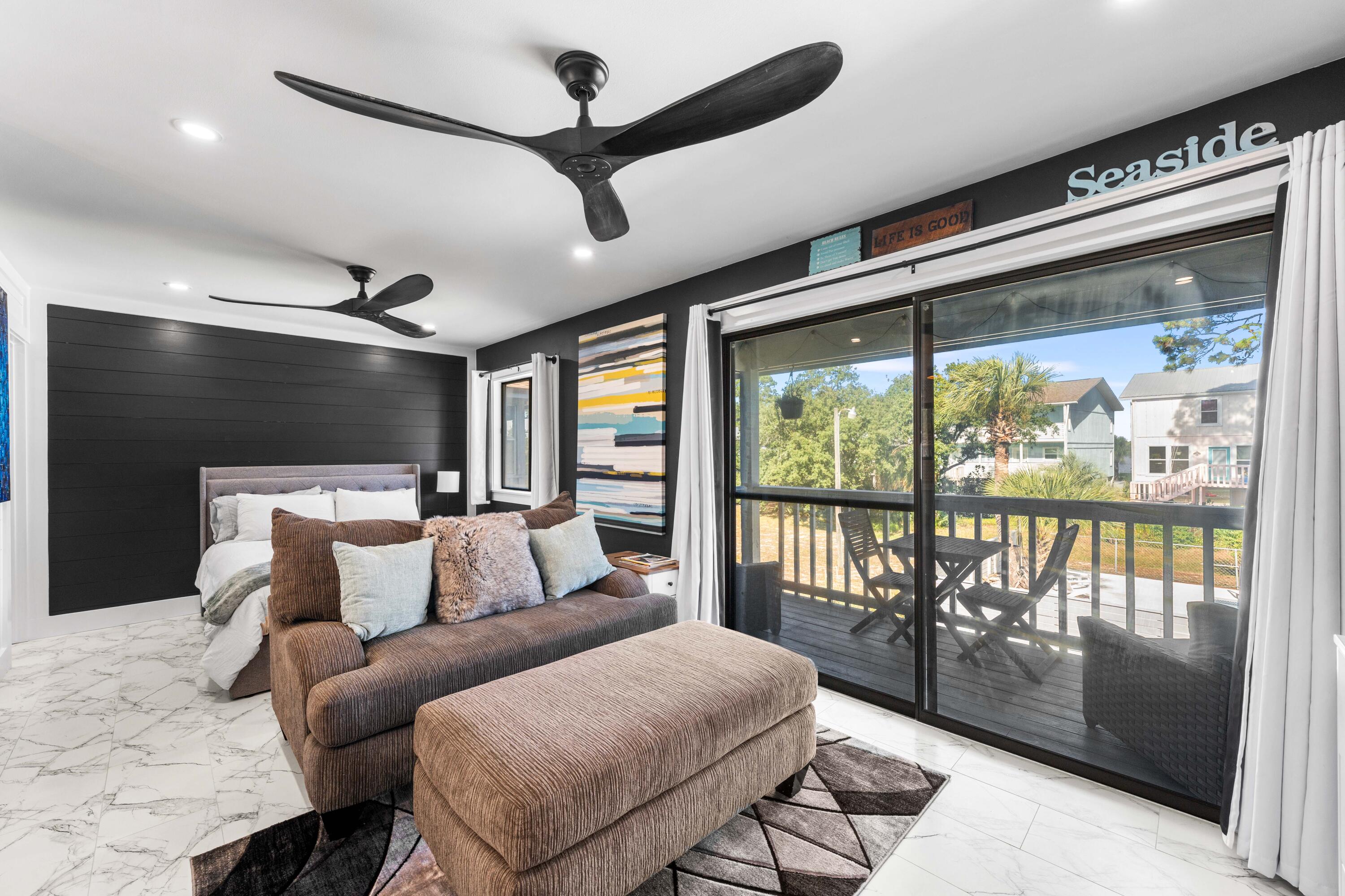 101 Cain Road, Unit O Panama City Beach, FL 32413 - Photo 9 of 29 a bedroom with furniture and a large window