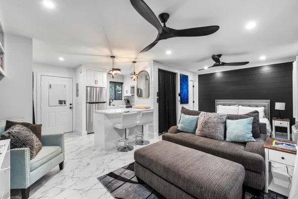 a living room with furniture and kitchen view