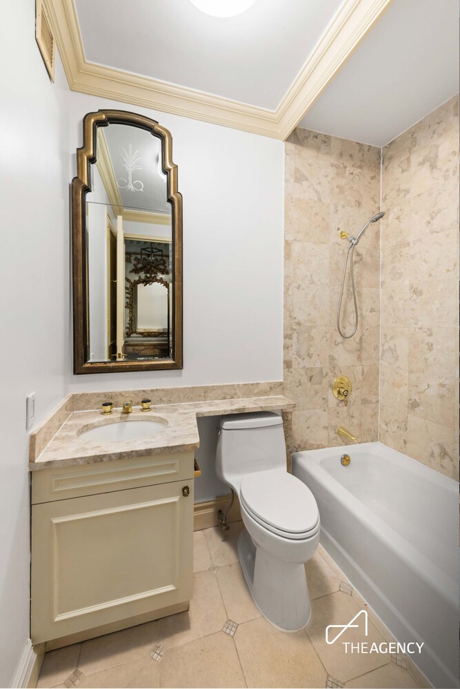 524 East 72nd Street, Unit 22D Manhattan, NY 10021 - Photo 10 of 12 a bathroom with a toilet a sink and bathtub