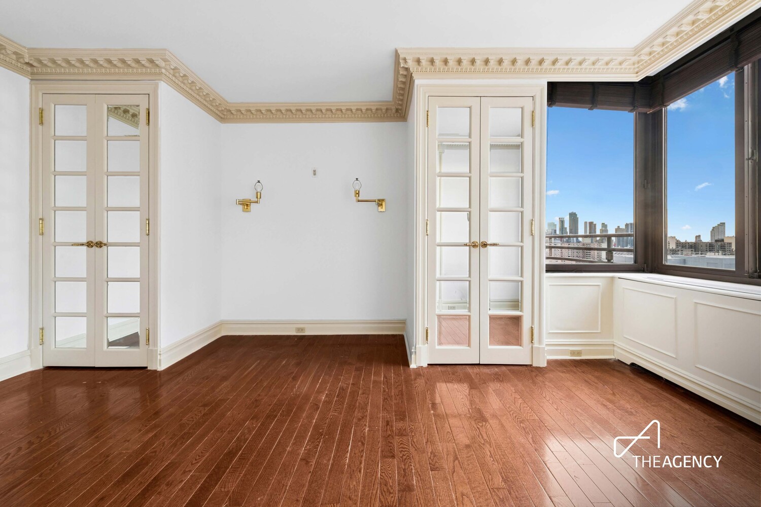 524 East 72nd Street, Unit 22D Manhattan, NY 10021 - Photo 2 of 12 an empty room with wooden floor and windows