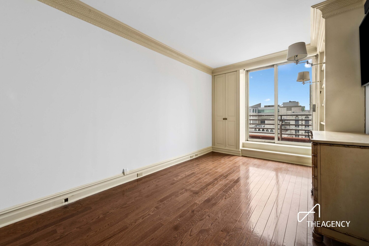 524 East 72nd Street, Unit 22D Manhattan, NY 10021 - Photo 4 of 12 an empty room with wooden floor and window