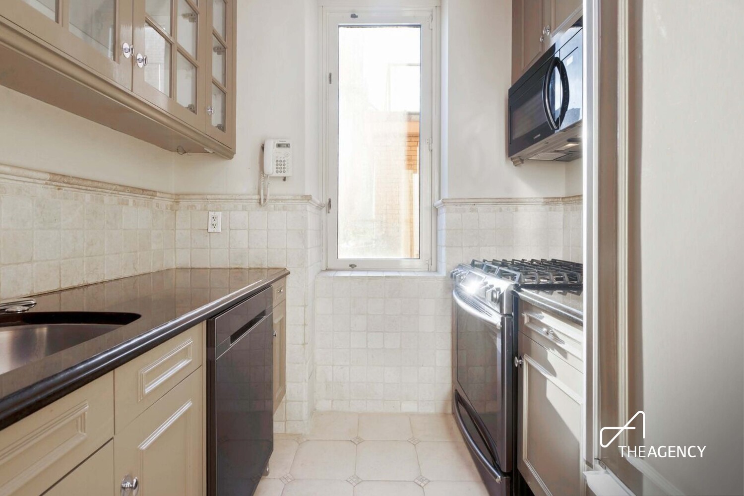 524 East 72nd Street, Unit 22D Manhattan, NY 10021 - Photo 8 of 12 a kitchen with a refrigerator and a sink