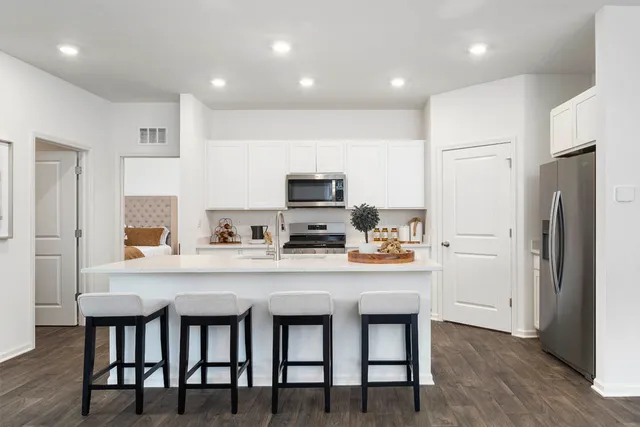 a kitchen with kitchen island appliances cabinets and furniture