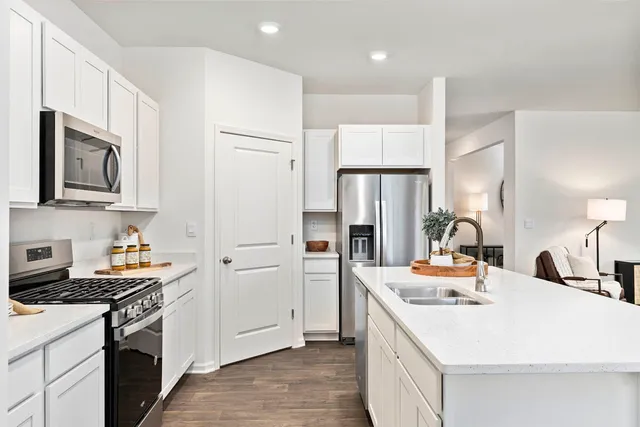 a view of living room with stainless steel appliances granite countertop furniture and a kitchen view
