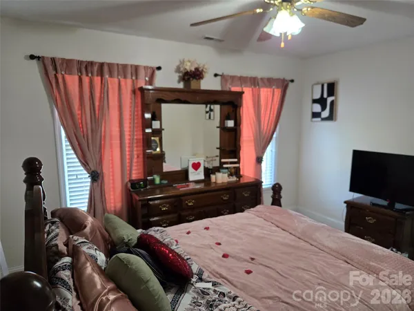 a bedroom with a bed and a television