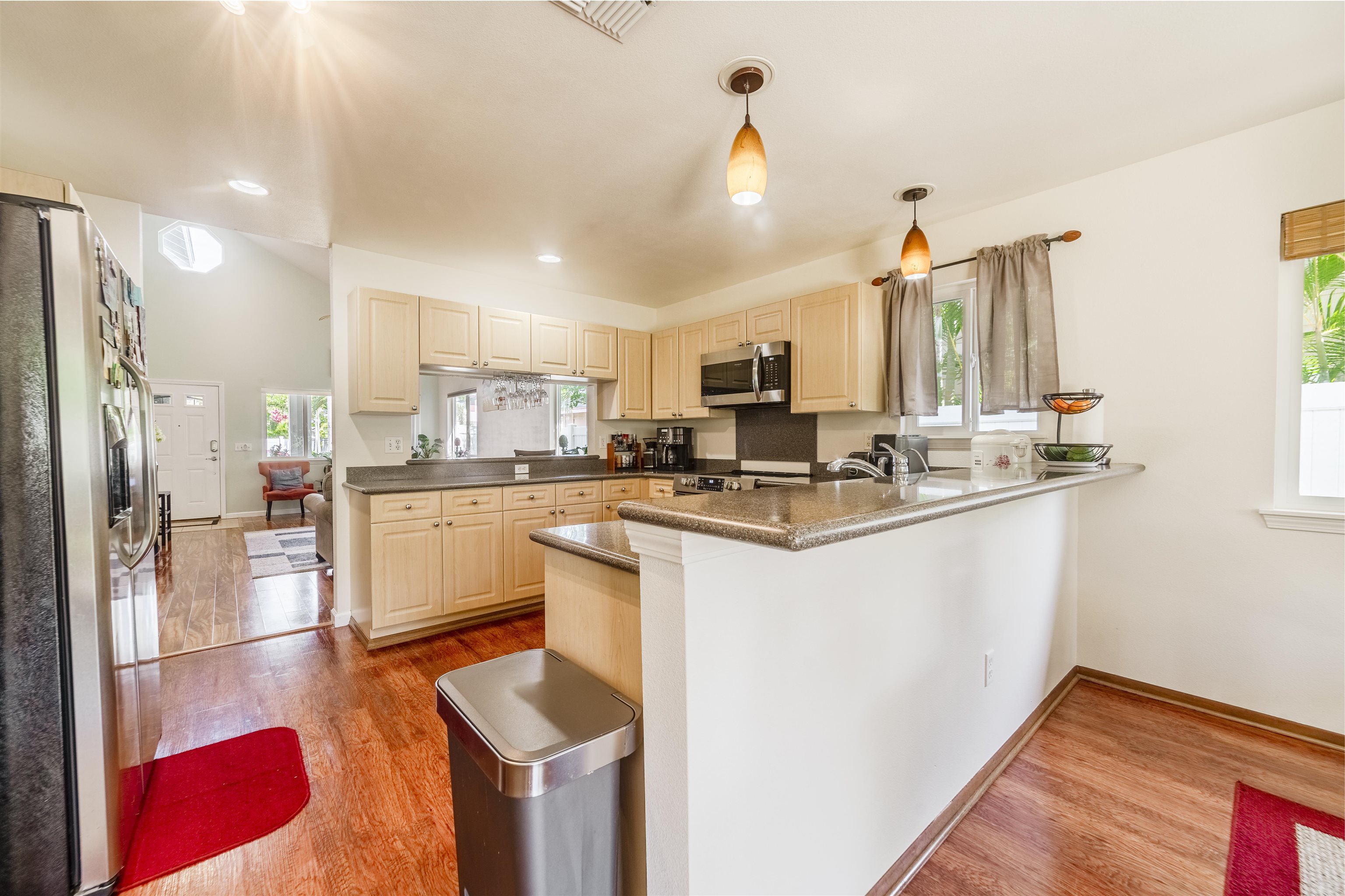 121 Molehulehu Loop Kahului, HI 96732 - Photo 12 of 43 a kitchen with kitchen island granite countertop a sink cabinets and refrigerator