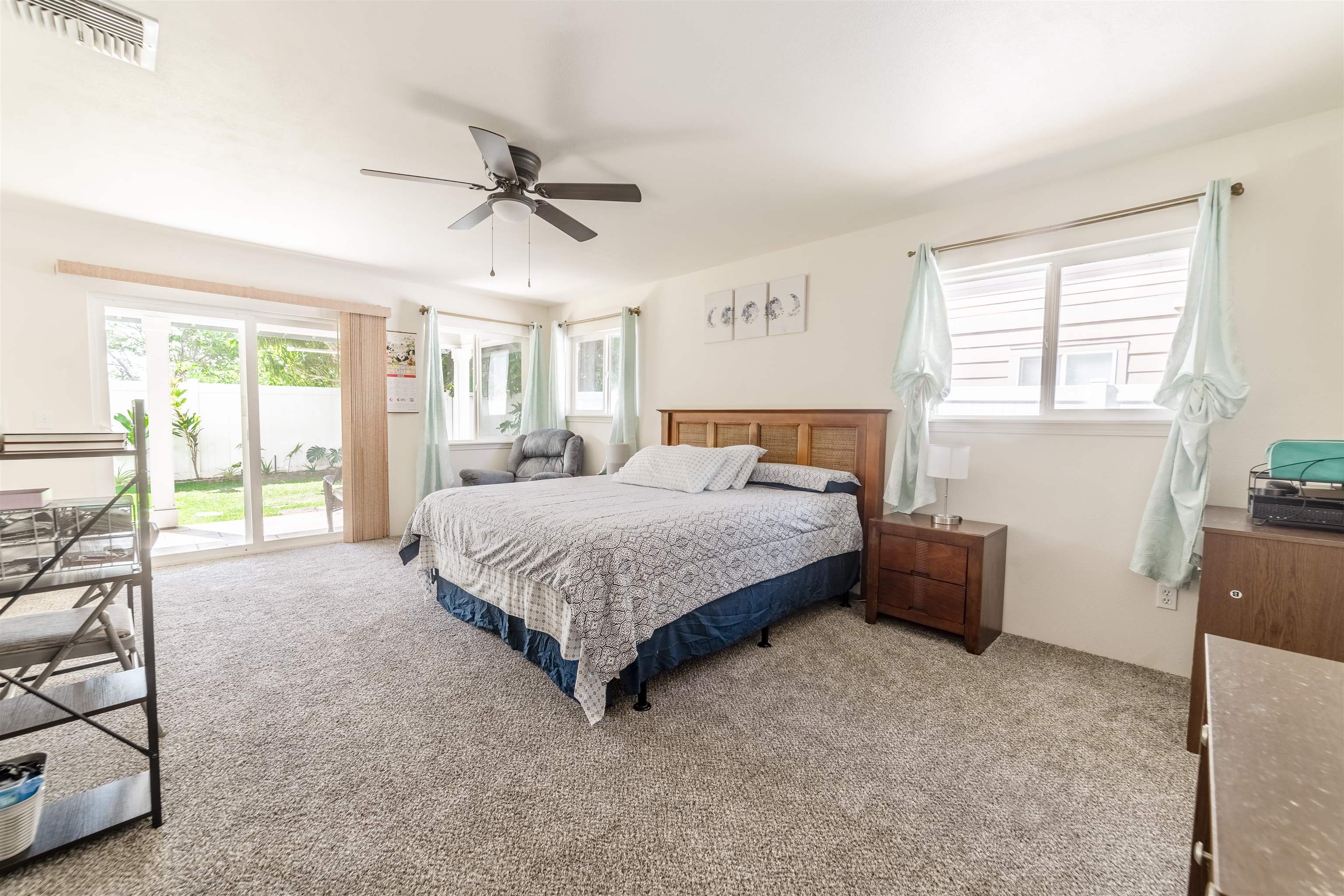121 Molehulehu Loop Kahului, HI 96732 - Photo 19 of 43 a bedroom with a bed windows and a chandelier