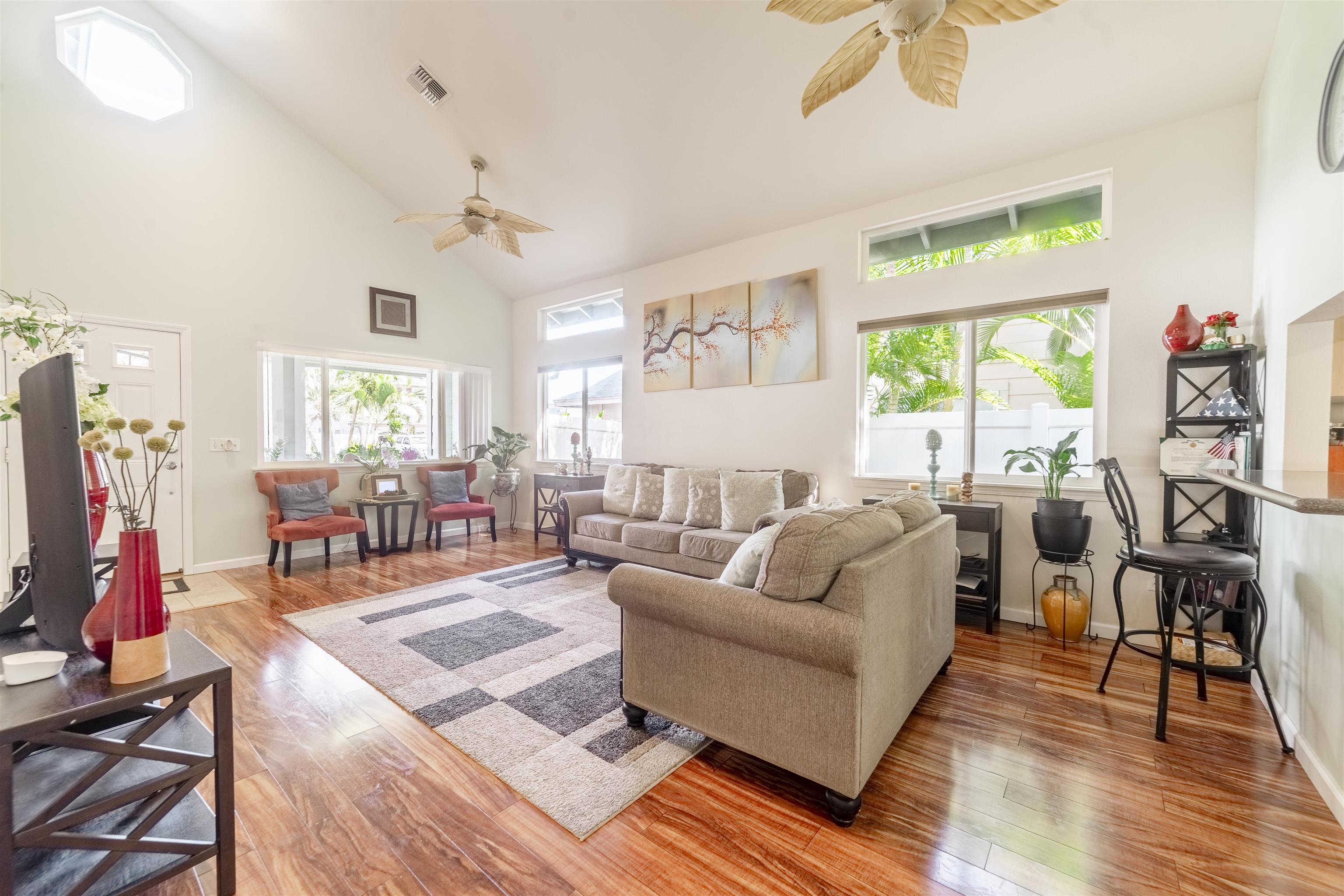 121 Molehulehu Loop Kahului, HI 96732 - Photo 6 of 43 a living room with furniture a large window and wooden floor
