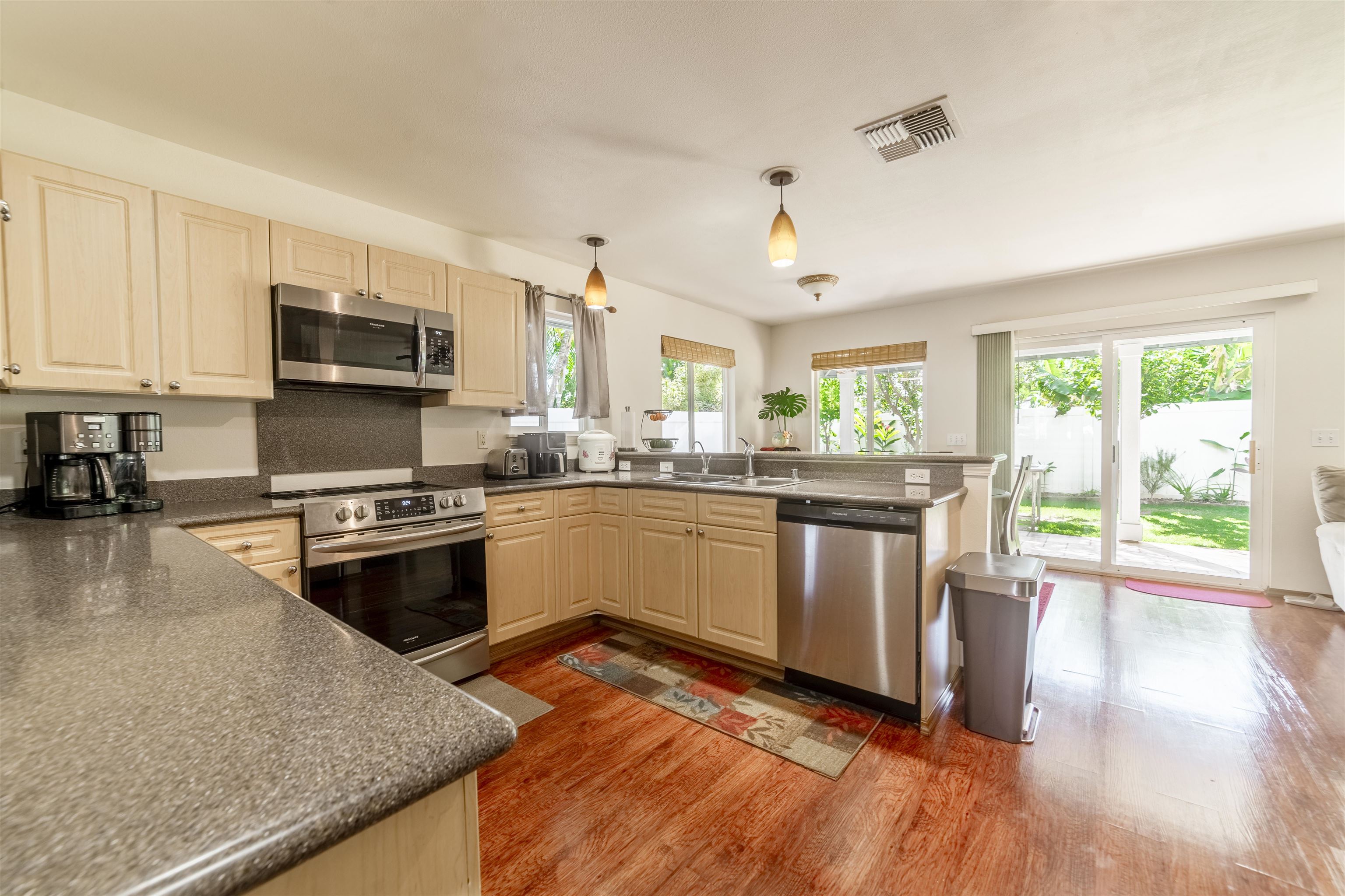 121 Molehulehu Loop Kahului, HI 96732 - Photo 10 of 43 a kitchen with stainless steel appliances granite countertop a stove a sink and a microwave
