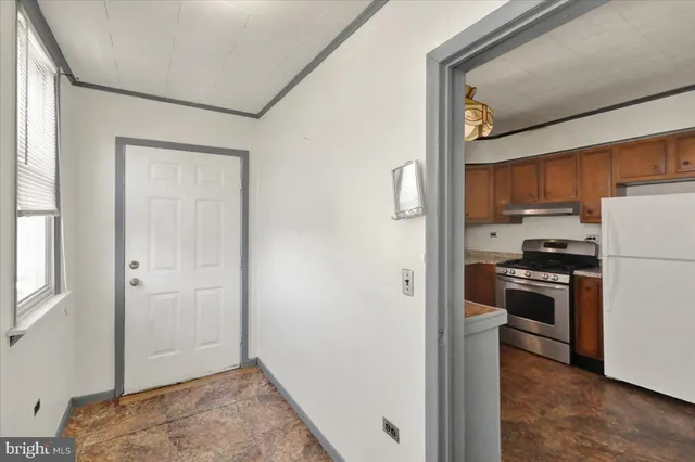 a kitchen with stainless steel appliances granite countertop a stove a sink dishwasher and a refrigerator