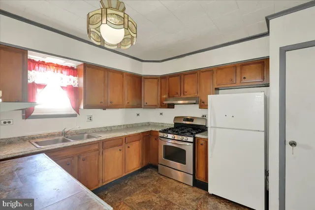 a view of a hallway with wooden floor and windows