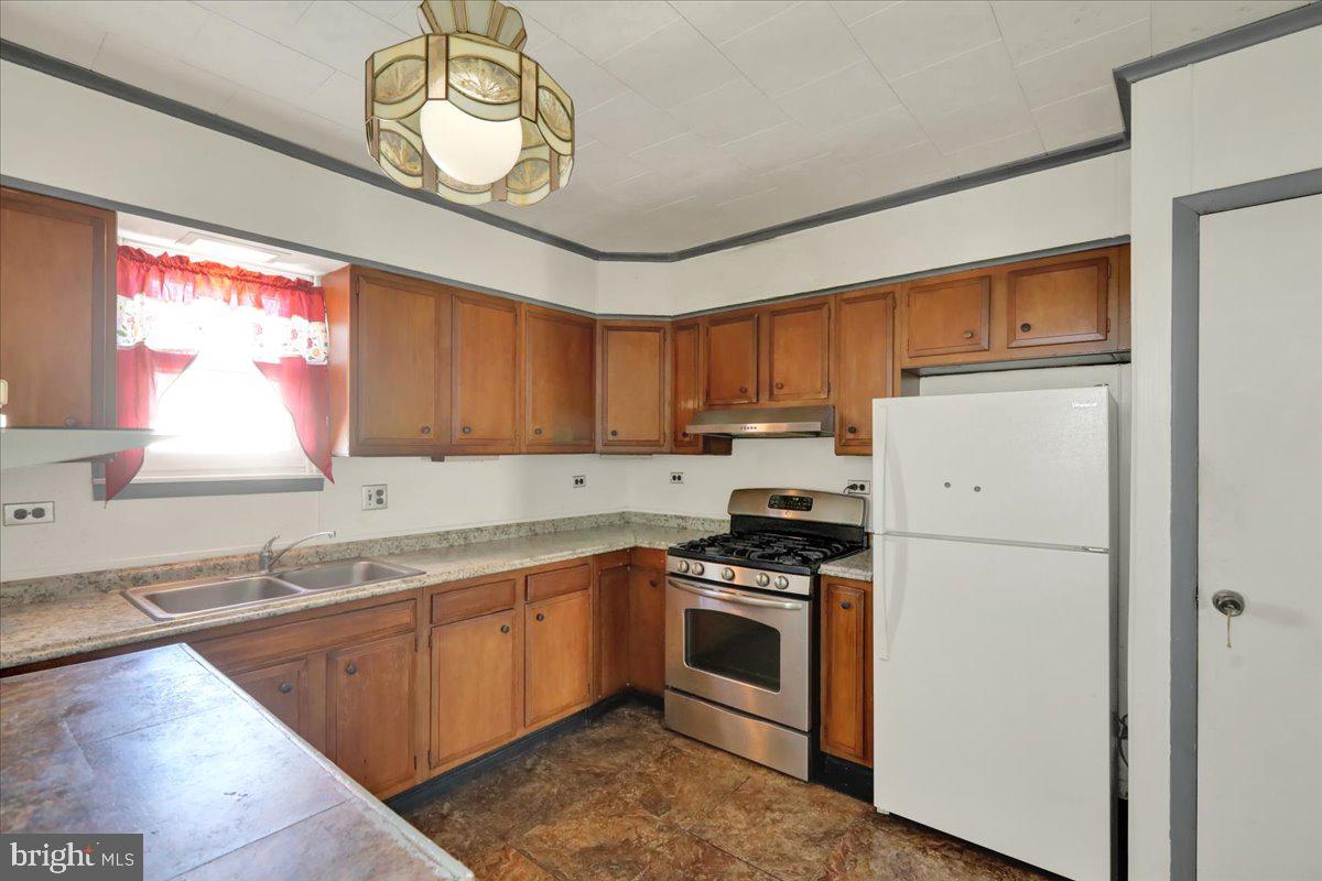 1129 East Greenwich Street Reading, PA 19604 - Photo 16 of 33 a kitchen with stainless steel appliances granite countertop a stove a sink dishwasher and a refrigerator