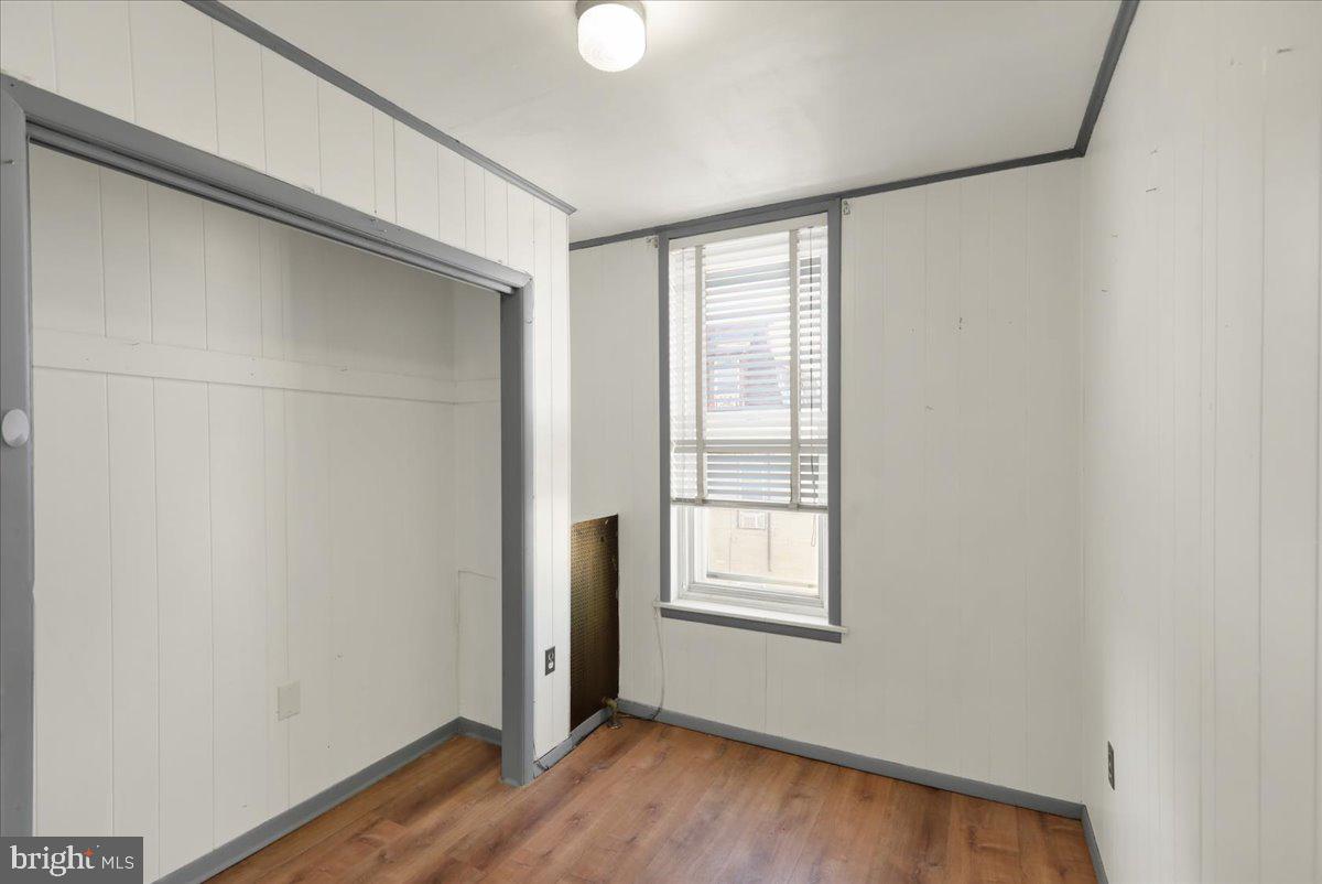 1129 East Greenwich Street Reading, PA 19604 - Photo 19 of 33 a view of an empty room with wooden floor and a window