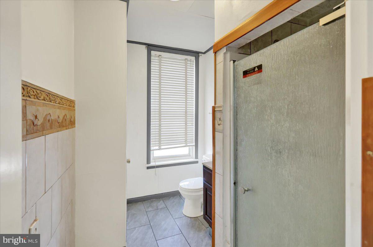 1129 East Greenwich Street Reading, PA 19604 - Photo 20 of 33 a bathroom with a toilet and a shower