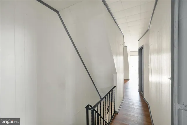 a view of a house with a wooden fence