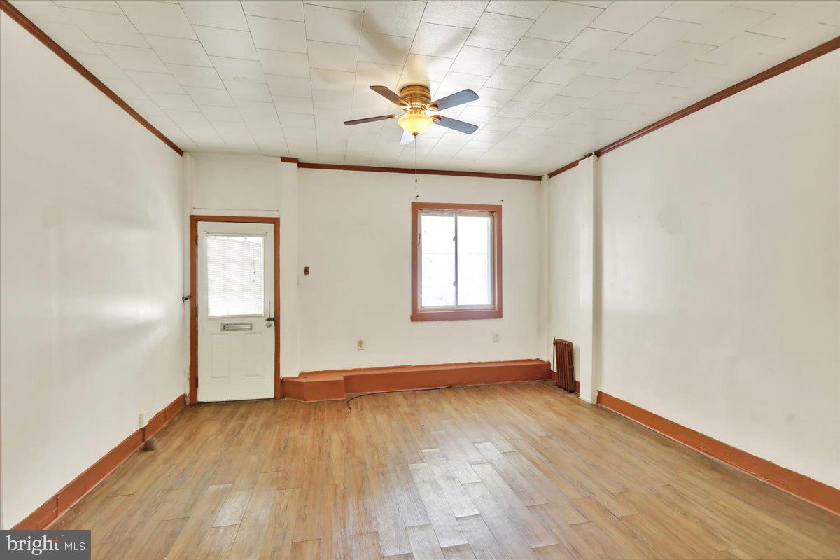 1129 East Greenwich Street Reading, PA 19604 - Photo 4 of 33 an empty room with wooden floor and windows