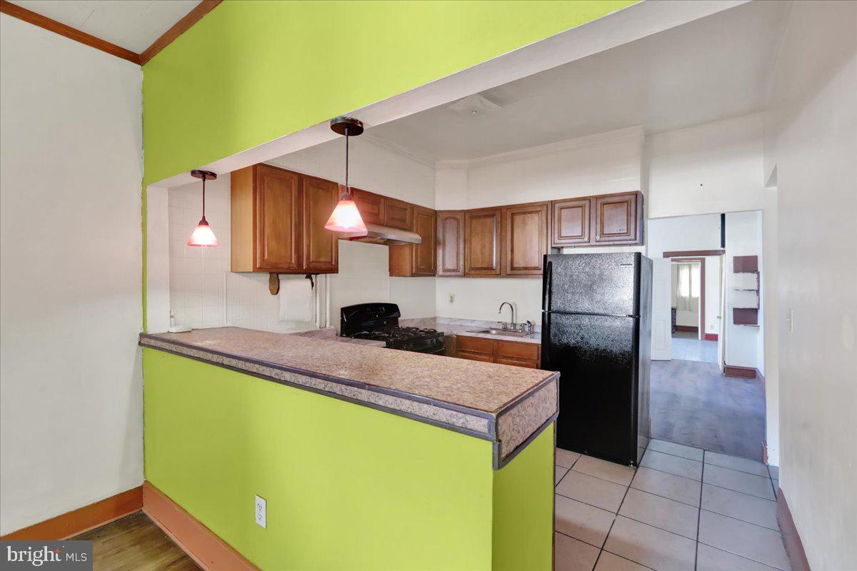 1129 East Greenwich Street Reading, PA 19604 - Photo 6 of 33 a kitchen with a refrigerator a sink and cabinets