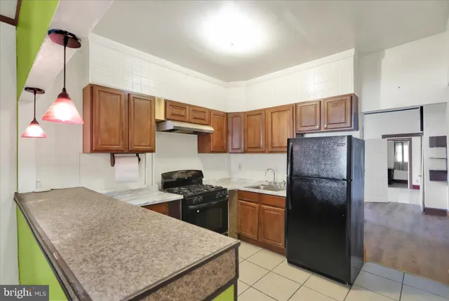 a kitchen with a sink refrigerator and microwave